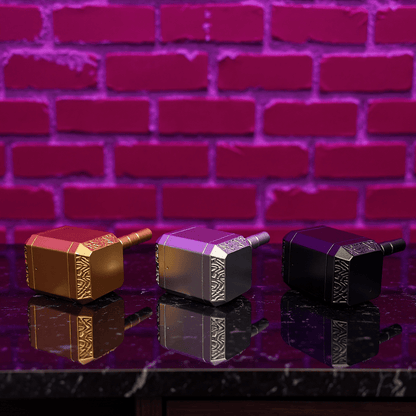 Thor Hammer Shape Grinder – 4 - Part Metal GrinderThree metallic grinders with decorative patterns on a reflective surface