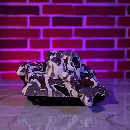 Camouflage - patterned toy tank grinder on a reflective surface with a brick wall background
