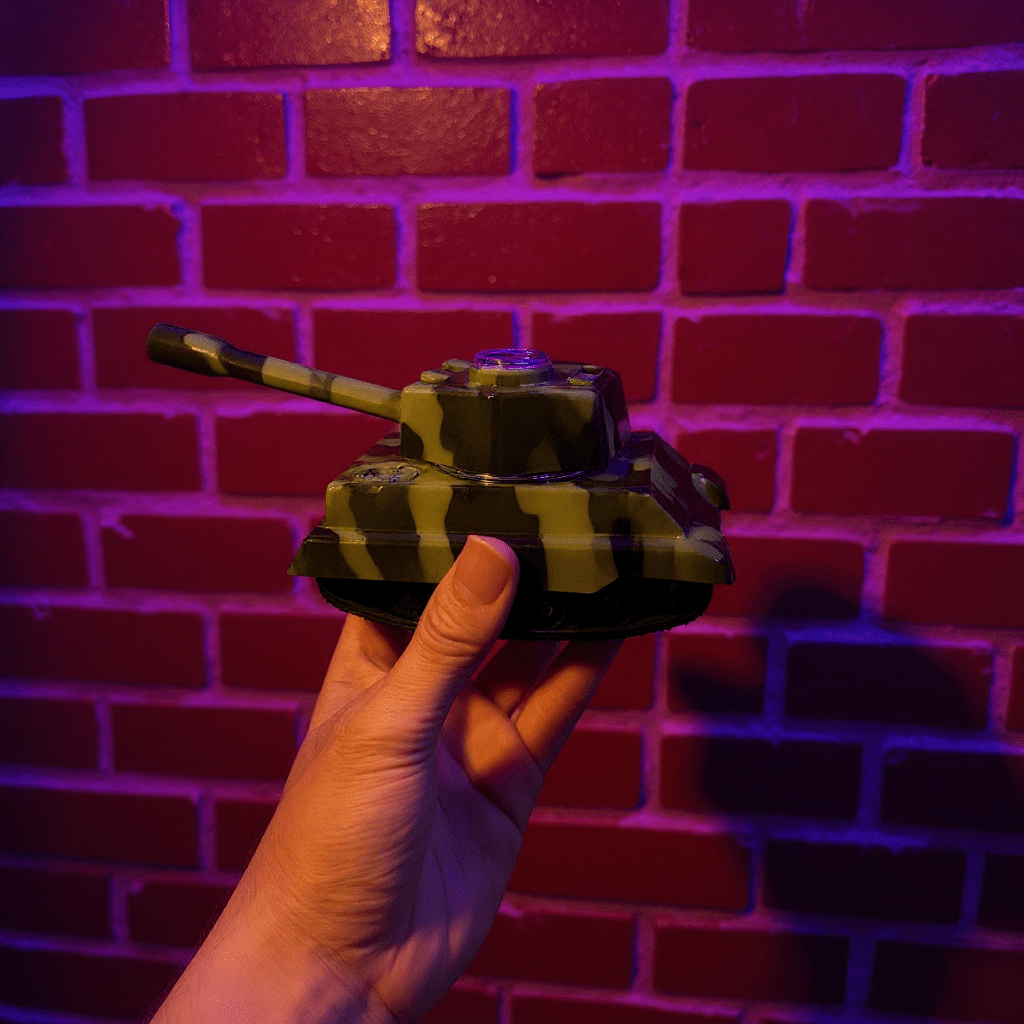 Tiger panzer tank grinder held in front of a brick wall with a colorful light effect